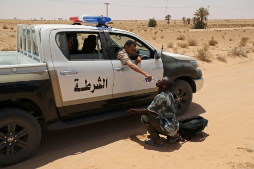 Libya border guards rescue migrants in desert near Tunisia