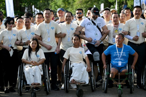 Survivors, sniffing dogs join anti-mine march at Cambodia's Angkor Wat