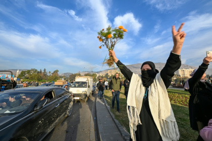 People at Umayyad Square in Damascus celebrate the end of Syrian president Bashar al-Assad's rule