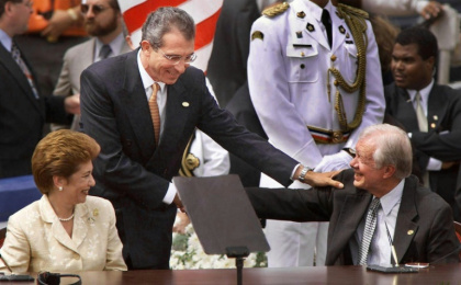 Panama's president Mireya Moscoso (L) looks on as her Mexican counterpart Ernesto Zedillo (C) congratulates former US president Jimmy Carter at the signing ceremony for the transfer of the Panama Canal to Panama in December 1999 in Panama City