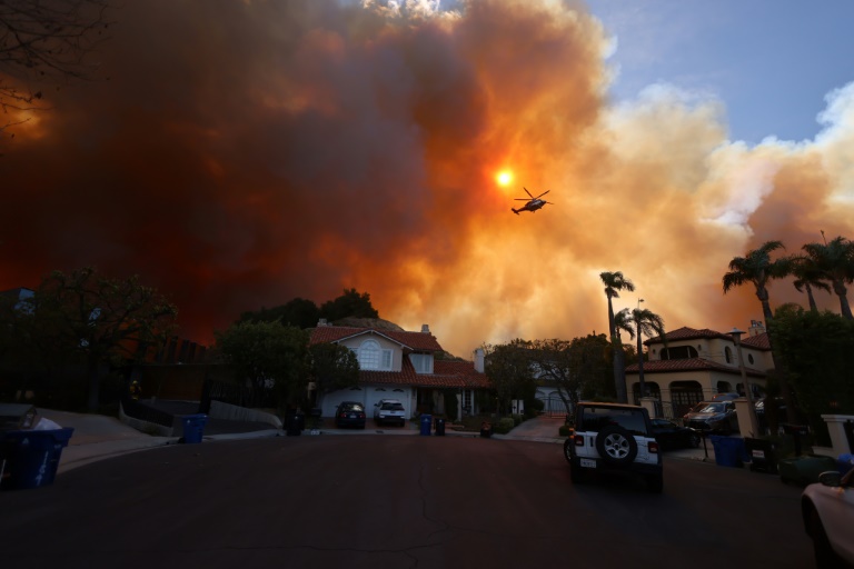 Wildfire sparks panicked evacuations in Los Angeles suburb