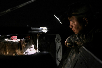 Hunter Zhang Tengfei looks on before a nighttime boar hunt