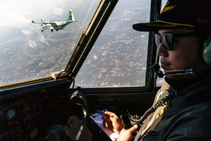 A pilot flies next to another aircraft from Thailand's Royal Rainmaking department spraying icy water in the air outside Bangkok in a bid to reduce pollution