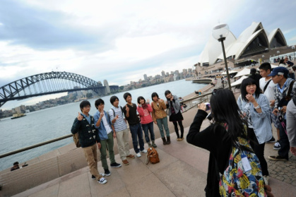 A group of Japanese tourists pose for photographs at Sydney Harbour in 2012. Today around 17.5 percent of Japanese citizens hold valid passports