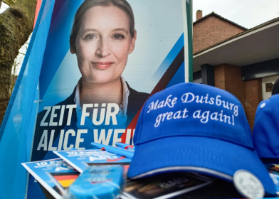 A poster of the Alternative for Germany's Alice Weidel and a 'Make Duisburg Great Again' cap at a stall of the far-rigth party in the western industrial town