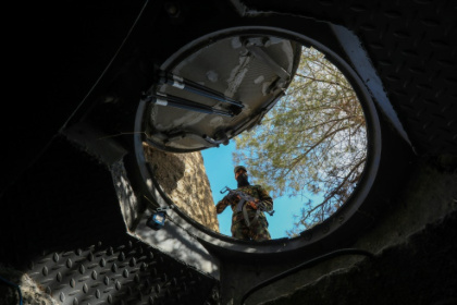 Mountain lair: a soldier looks into a hidden exit from from Maher al-Assad's private office built into a hilltop overlooking Damascus