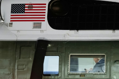US President Donald Trump looks at his cellphone aboard Marine One - SAUL LOEB (AFP) US President Donald Trump looks at his cellphone aboard Marine One - SAUL LOEB (AFP)