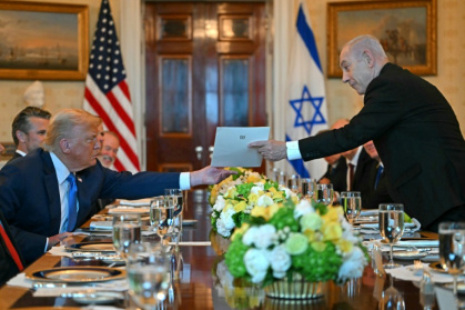 Israeli Prime Minister Benjamin Netanyahu hands over a letter to US President Donald Trump as they meet at the Blue Room of the White House - ANDREW CABALLERO-REYNOLDS (AFP) Israeli Prime Minister Benjamin Netanyahu hands over a letter to US President Donald Trump as they meet at the Blue Room of the White House - ANDREW CABALLERO-REYNOLDS (AFP)